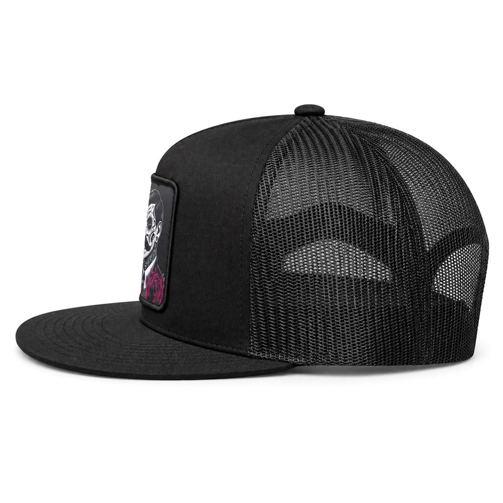 A black trucker-style baseball cap with a black mesh back and a black fabric brim, featuring gold contrast stitching along the edge of the brim and a small white logo patch on the side.