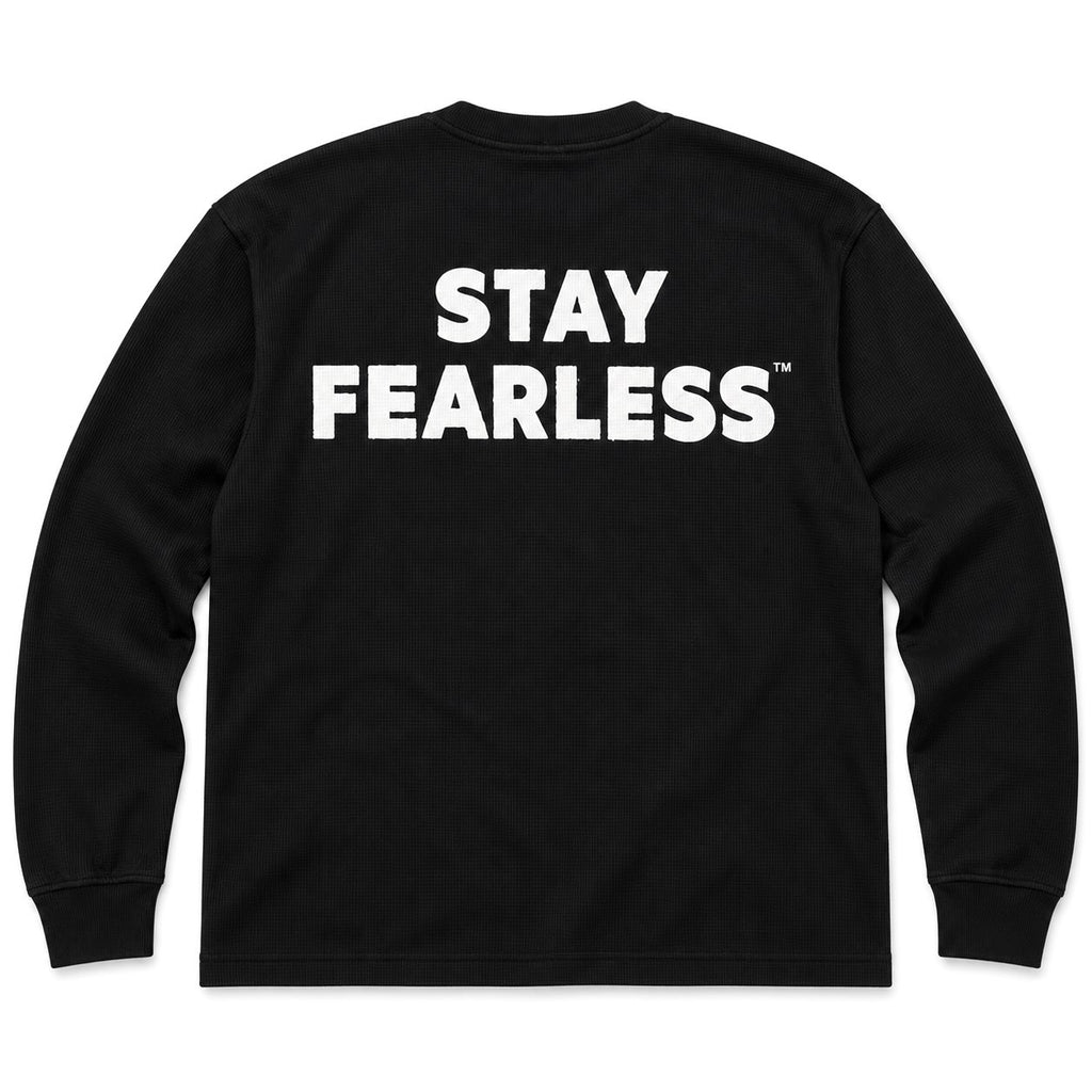 A black long-sleeve waffle-knit t-shirt with 'STAY FEARLESS' printed in bold white capital letters across the chest, shown against a plain white background.