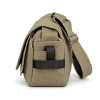 An olive green canvas messenger bag with black accents and a wide adjustable shoulder strap, shown on a clean white background.