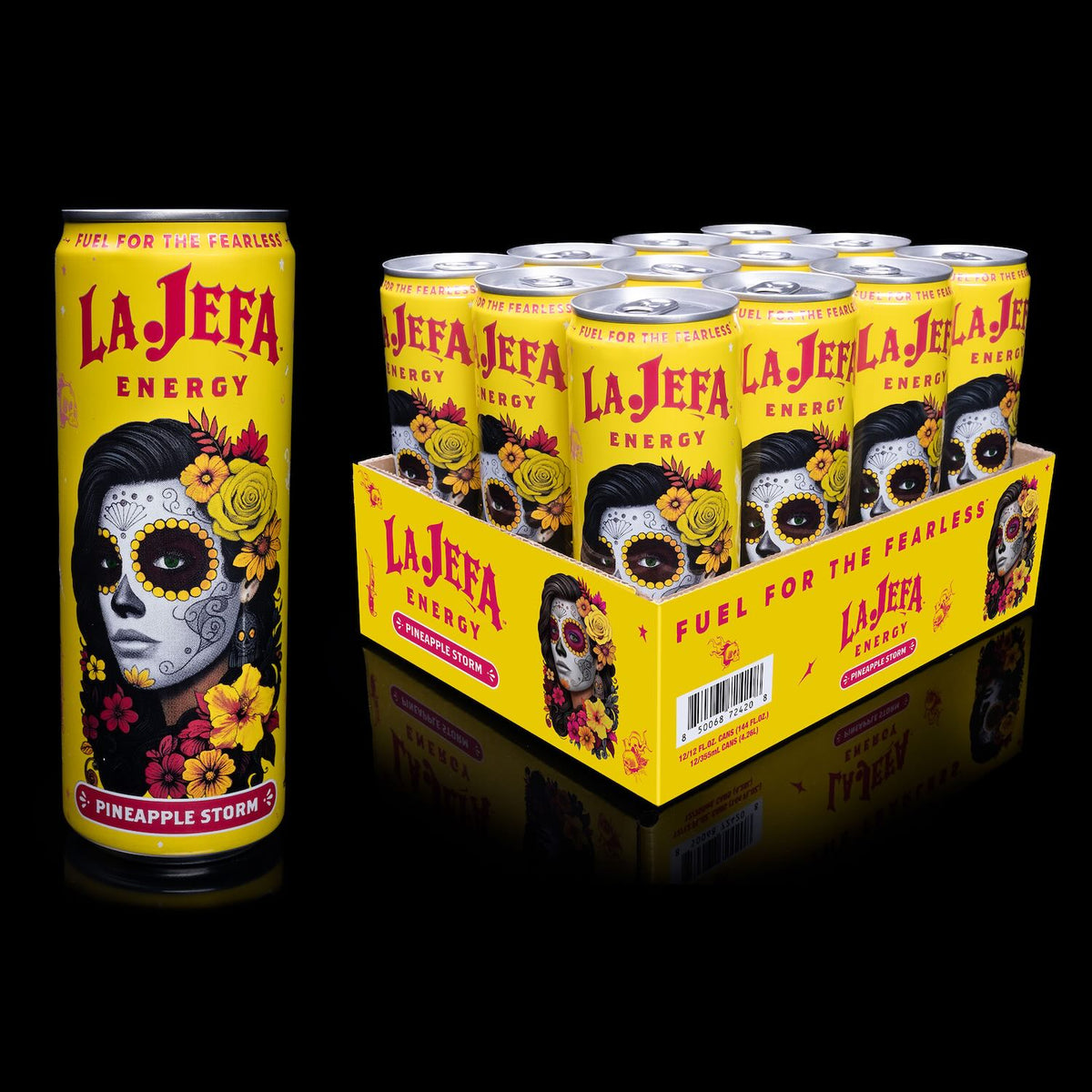 A single La Jefa Energy can of Pineapple Storm alongside a bulk display tray of multiple matching cans, photographed on a black reflective studio background.