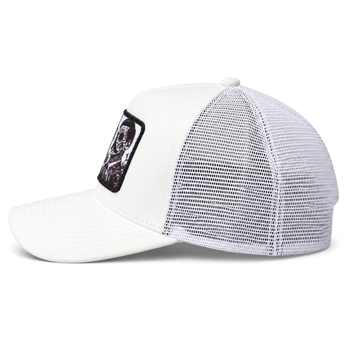 A white suede trucker-style cap with a white mesh back and a black rectangular patch on the side featuring a graphic of a skull.